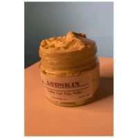 a jar of body butter sitting on a table
