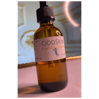 a bottle of godskin oil on a table